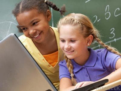 two-little-girls-in-classroom-looking-at-computer